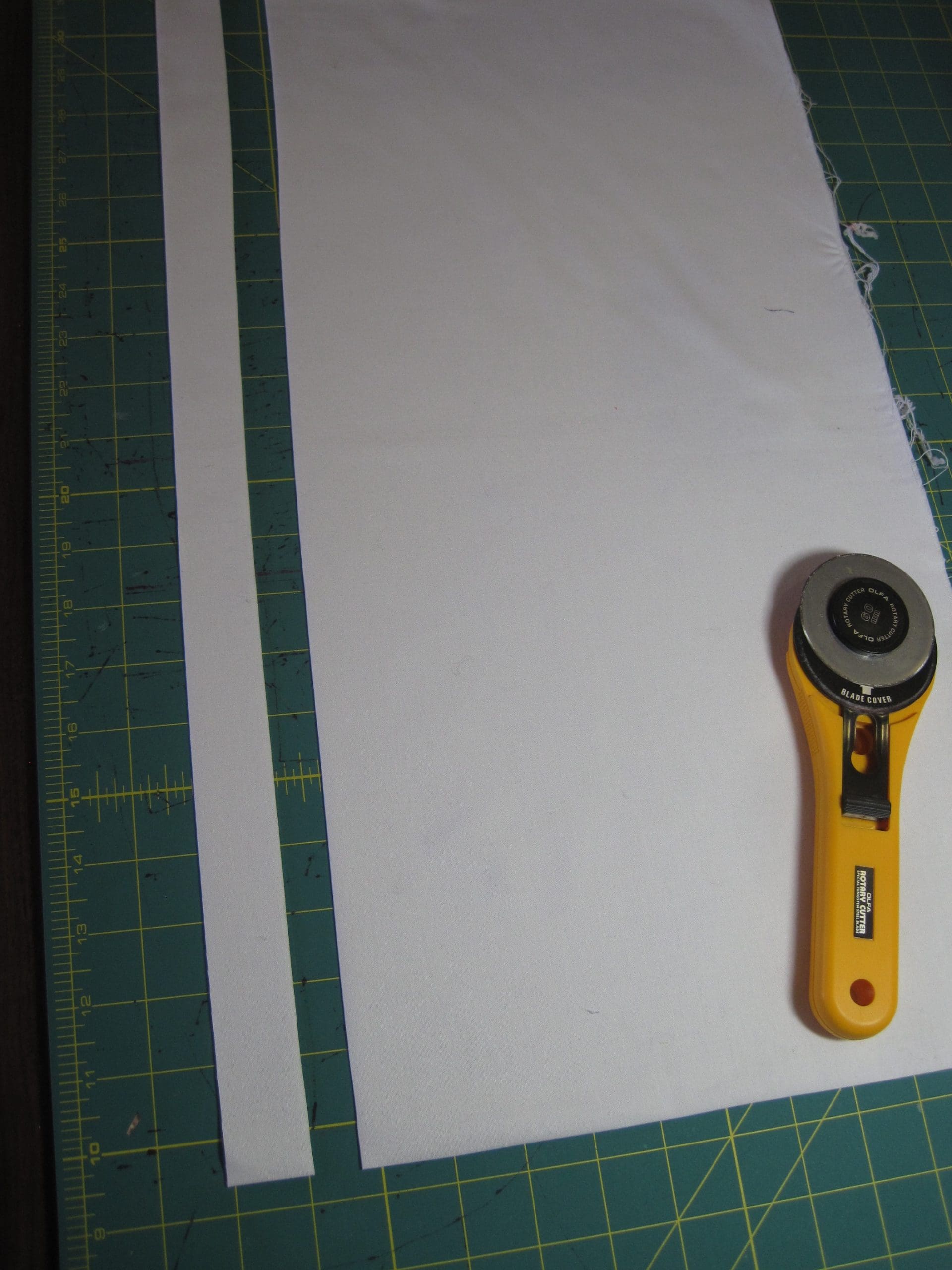 I then make the cut. I cut moving the blade away from me. Before I start cutting I think about the size I want. I tell myself that I want to cut a 1 1/4" strip, I visualize it, and then using the guidelines on the mat, I cut. This gives me a personally cut line which is much more interesting than a ruler cut line. But it is not so crazy that I can't stitch it accurately.