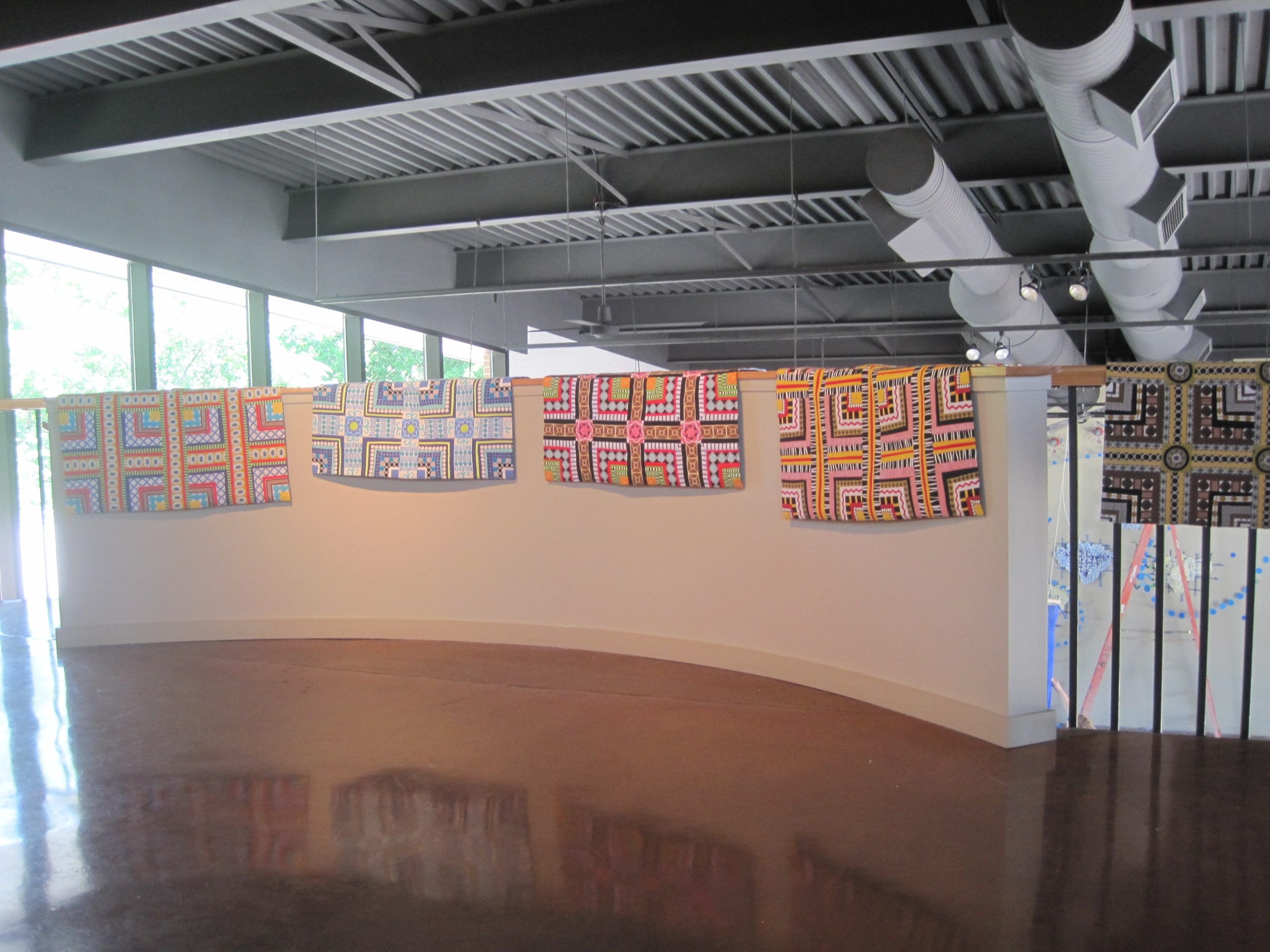 Here are the quilts resting on the ralings of the gallery.